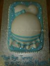blue and white belly baby cake with bow and baby items
