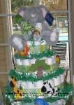 jungle animals diaper cake with plaid ribbon and jungle wooden shapes with grey elephant on top