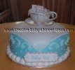 elegant baby boy shower cake with edible tea cup on top with baby sleeping inside