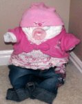 cute diaper baby in floral pink shirt and baby jeans