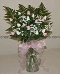 pink and white sock rose bouquet filled in with greenery and white baby's breath flowers