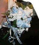 blue and white baby sock corsage with sock roses white flowers and mini blue pacifiers