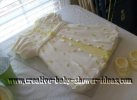 white and yellow baby dress cake