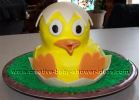 bright yellow hatching baby duck in shell cake
