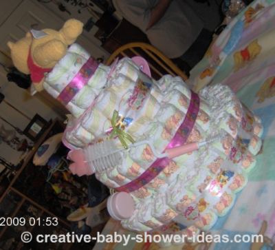 back view of pink winnie the pooh diaper cake