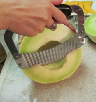 cutting honeydew spears for fruit bouquet