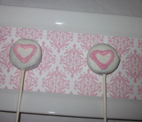 shite chocolate covered oreo lollipops with pink hearts