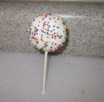 white oreo cookie pops with colored sprinkles