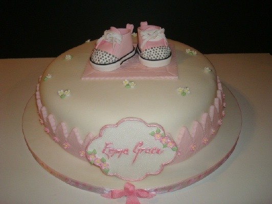 delicate pink and white baby bootie cake with edible rhinstones on sneakers