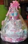 diaper cake with pink ribbon and bib that says I love mommy and daddy