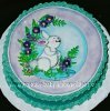white bunny rabbit cake with teal frosting ruffled edges