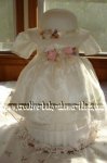 cream heirloom dress covering a diaper cake