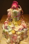 pink and yellow teether diaper baby cake