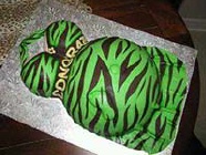 green and brown zebra belly dress cake with baby foot showing through dress