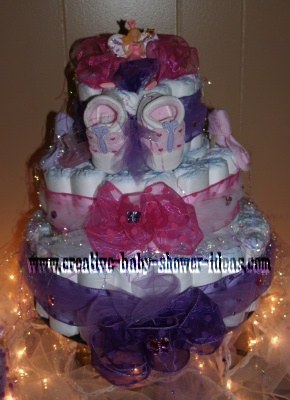 3 tier diaper cake with pink and purple organza bows and ribbo