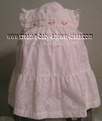 white dress with pink roses covering diaper cake