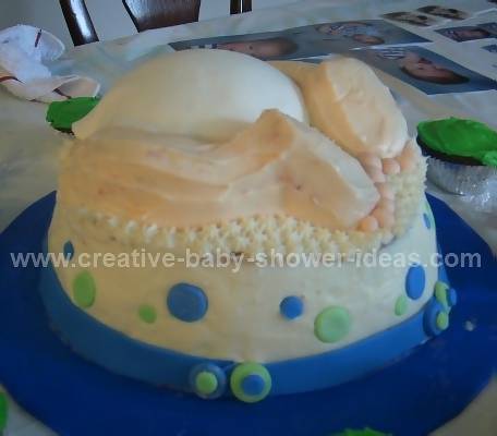 side view of baby crash cake showing diaper and legs sticking out of it
