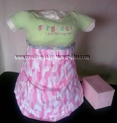 baby diaper cake with green onesie and pink cameoflauge skirt