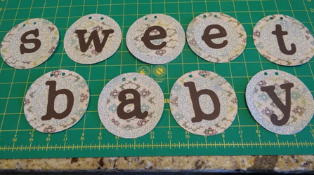 baby shower banner circles with hole punches in top of circles