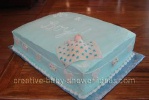 blue blanket cake with sleeping baby and clothesline