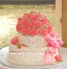 white cake covered with pink roses