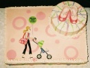 sheet cake with mod mom pushing stroller design and baby booties on 2 tier