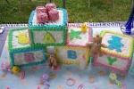 baby blocks cake trimmed in bright edge colors and baby letters on them