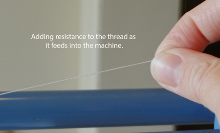 adding resistance to thread as it goes into the machine