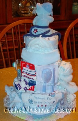 back of baseball diaper cake showing baby supplies and bib