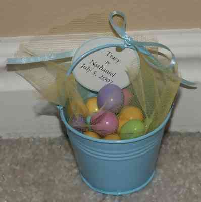 blue bucket with pastel candies for baby shower favor