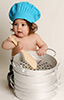 baby with big pot and spoon and blue chef hat