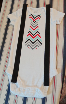 lining up suspender strips on baby onesie