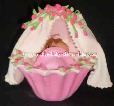 pink and white baby shower bassiner cake topper