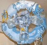 baby wreath with baby clothing and toys