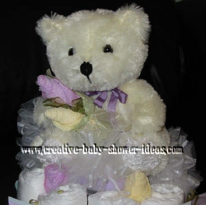 closeup of ballerina bear and sock roses on diaper cake