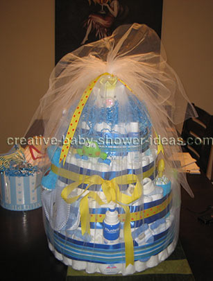 yellow and blue boy diaper cake with piggy bank wrapped in tulle