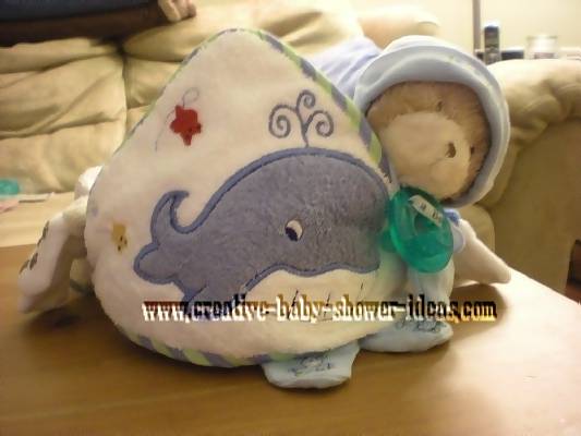 front of blue towel cupcake with teddy bear and pacifier