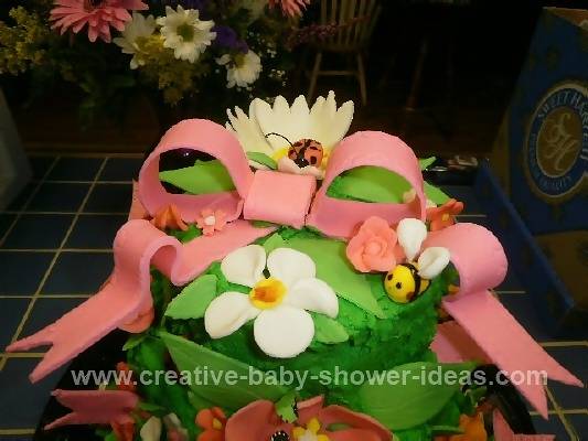 Closeup of Green Baby Bug Cake with Flowers