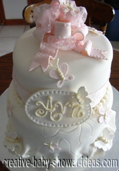 closeup of butterfly baby shower cake showing pink fondant bow