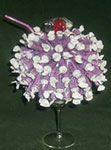 purple candy sundae centerpiece in ice cream glass with straw and red candy for the cherry