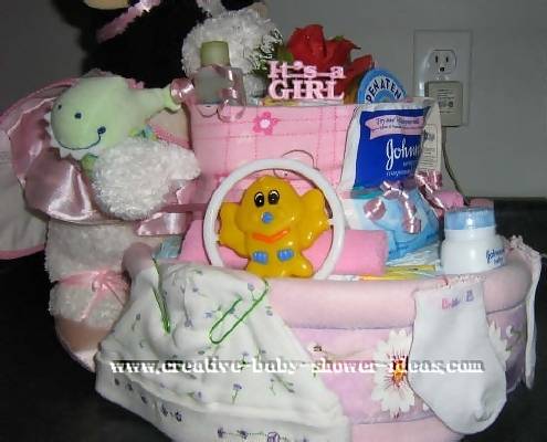 side of cow diaper cake showing pink and white decorations