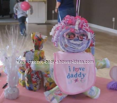 diaper baby with pink bib and curling ribbon hair