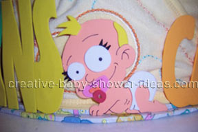 closeup of crawling baby girl on diaper cake