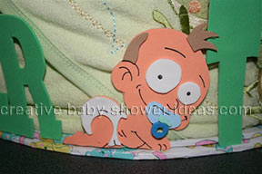 closeup of crawling boy baby on diaper cake