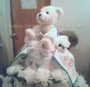 side view of white and blue bear diaper cake