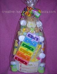 teddy bear and xylophone diaper cake wrapped in cellophane