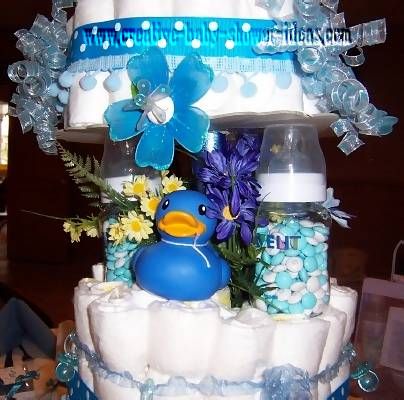 closeup of bottle pillars filled with m&ms on diaper cake