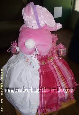 baby of pink bunny diaper cake showing 2 cute dresses