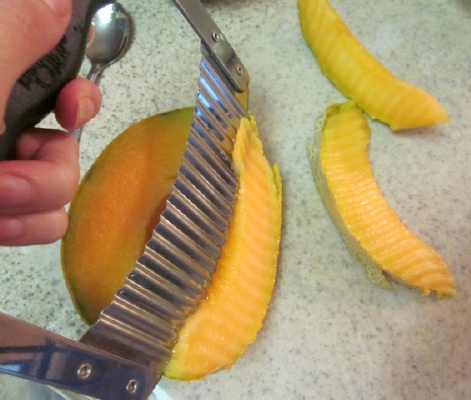 cutting cantaloupe spears for fruit bouquet