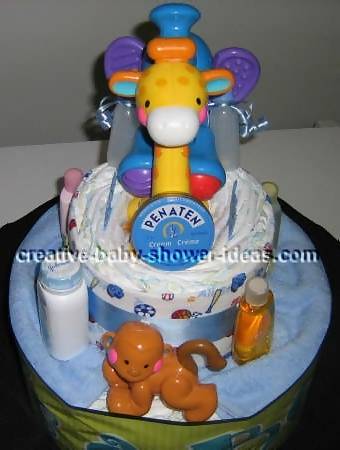 front of jungle diaper cake showing plastic giraffe, monkey and elephant